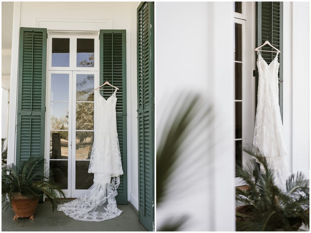 stella york wedding gown hanging on green shutters 