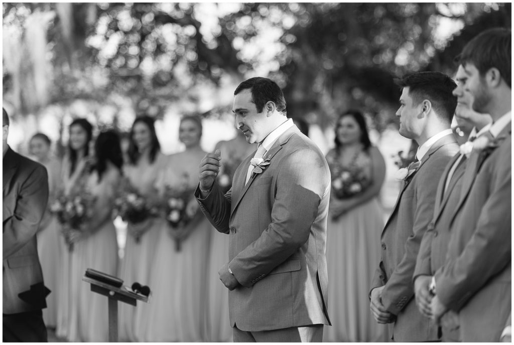 groom reacts as bride walks down the aisle