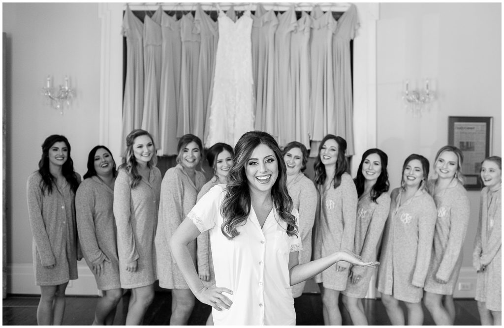 bride poses with bridesmaids in matching monogrammed pajamas