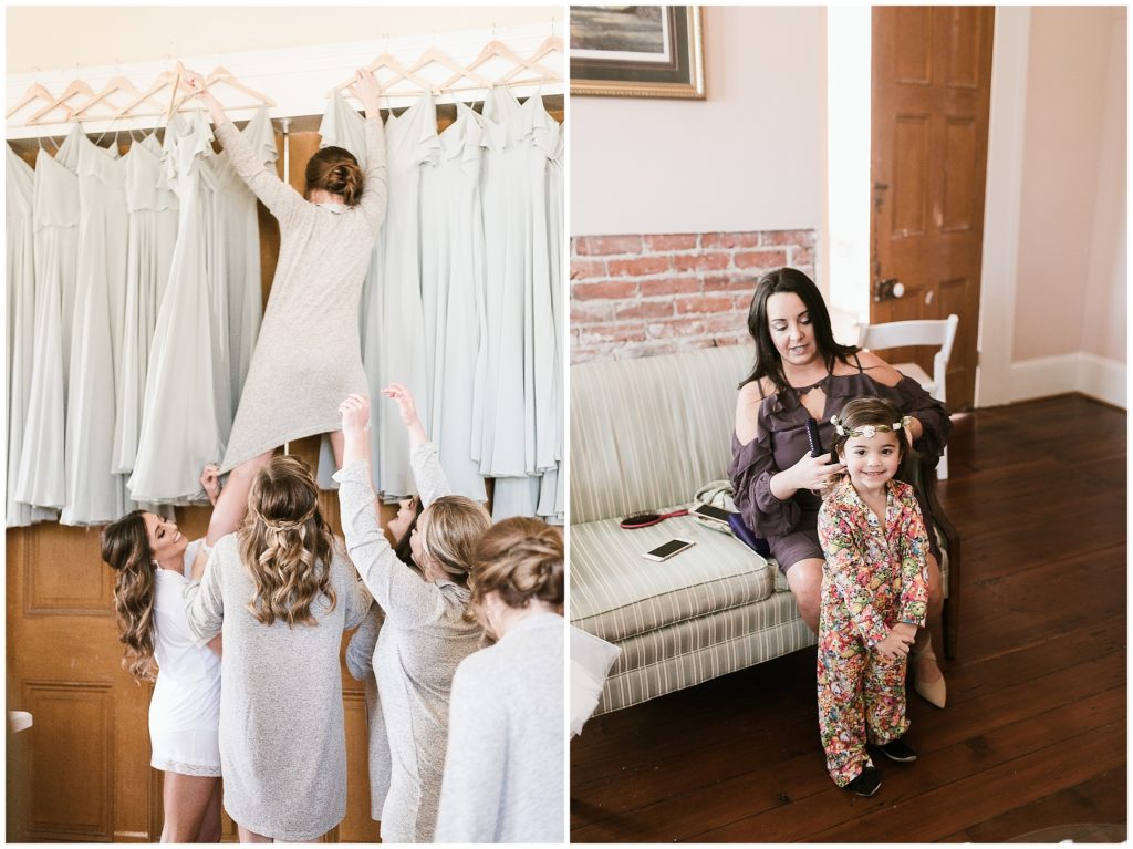 bridesmaids reach for dresses while flower girl puts on a flower crown