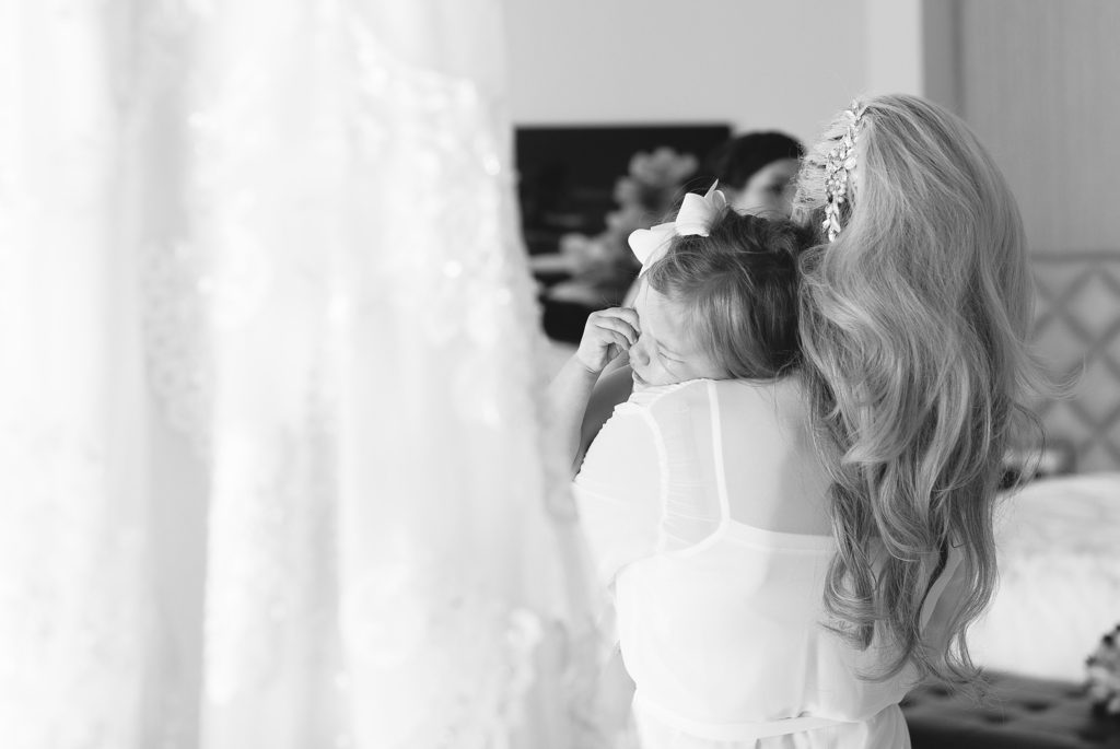 Bride consoling daughter.