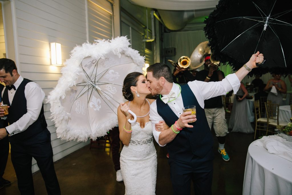 new orleans wedding bride and groom second line with umbrellas 