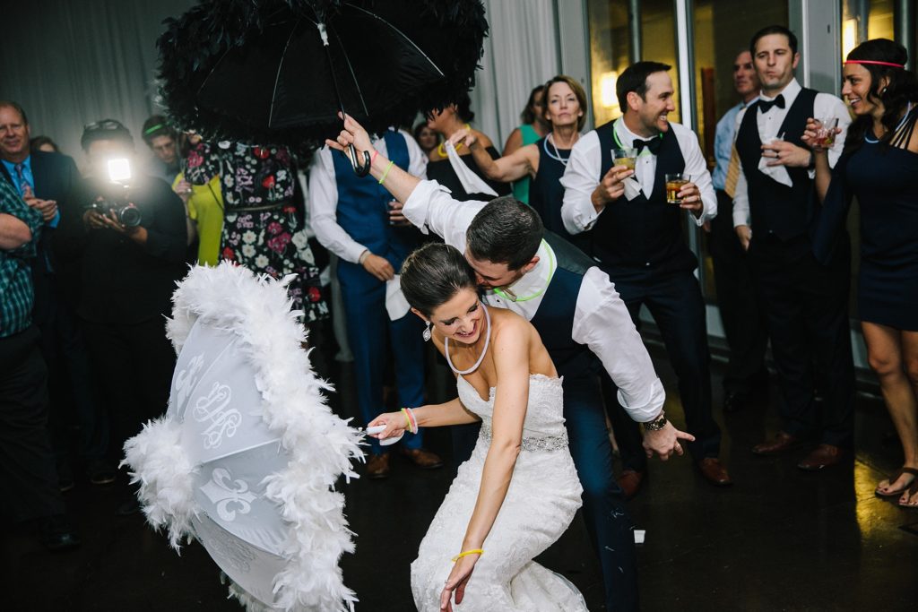 new orleans wedding bride and groom second line with umbrellas 