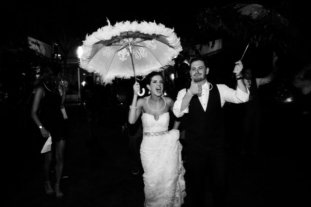 new orleans wedding bride and groom exit reception with second line with umbrellas 