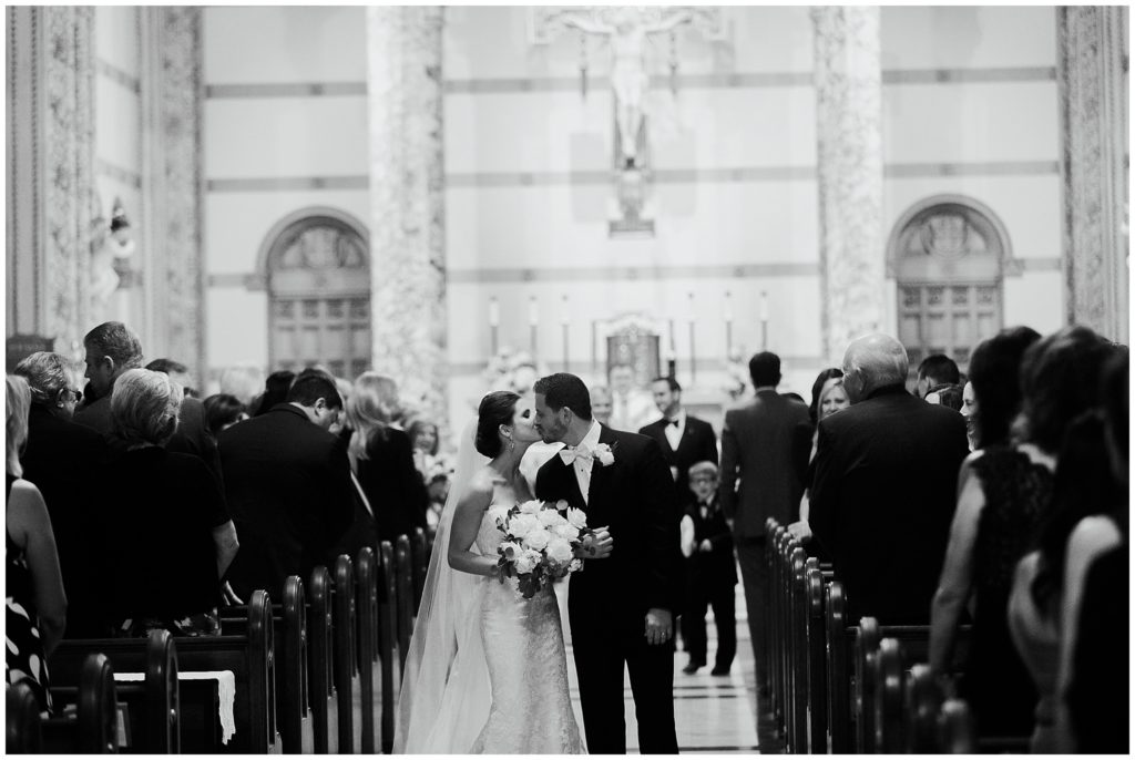 bride and groom kiss in st anthony of padua in new orleans