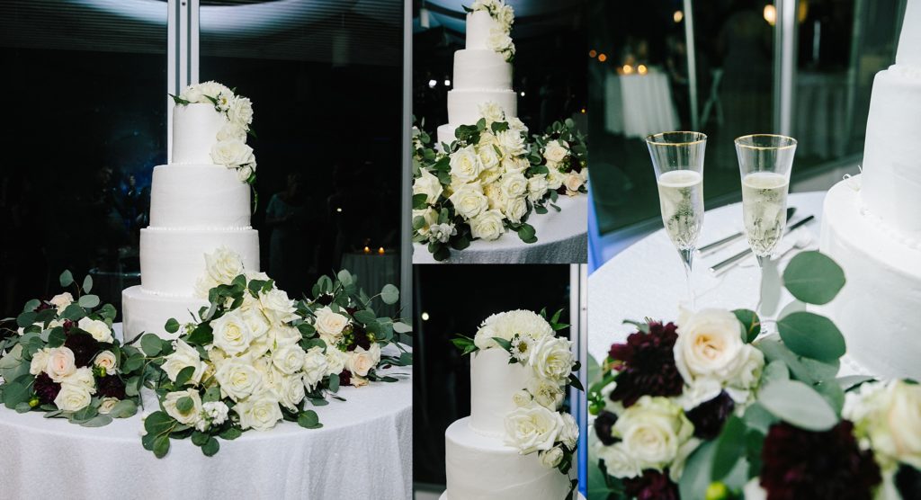four tier wedding cake decorated with white roses