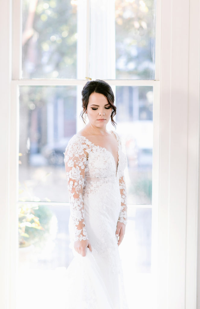 bride in front of large window bridals