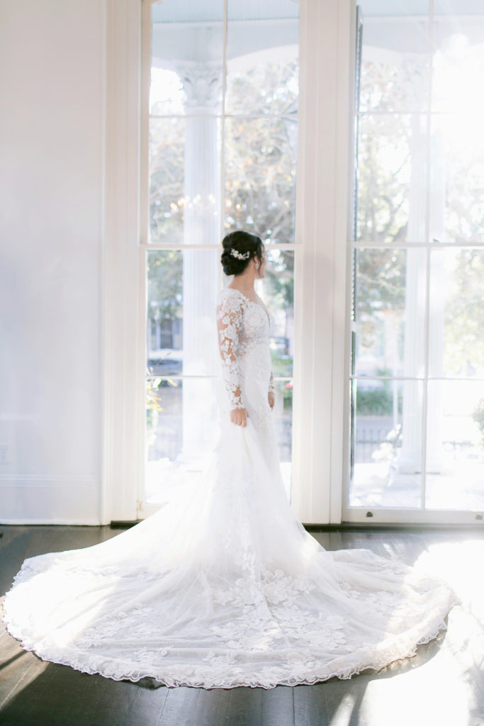 bride in front of large windows in martina liana gown