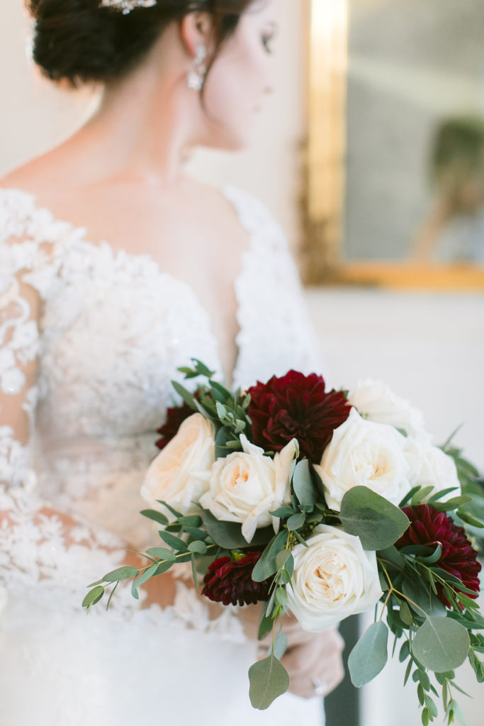 bride with close up of burgundy and white flowers