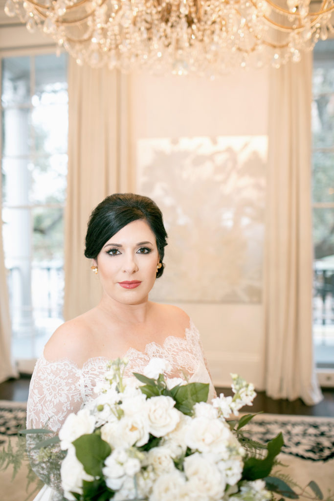 bride poses with white bouquet at jon vaccari house