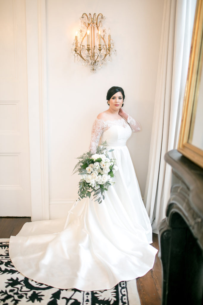 bride poses with white bouquet at jon vaccari house