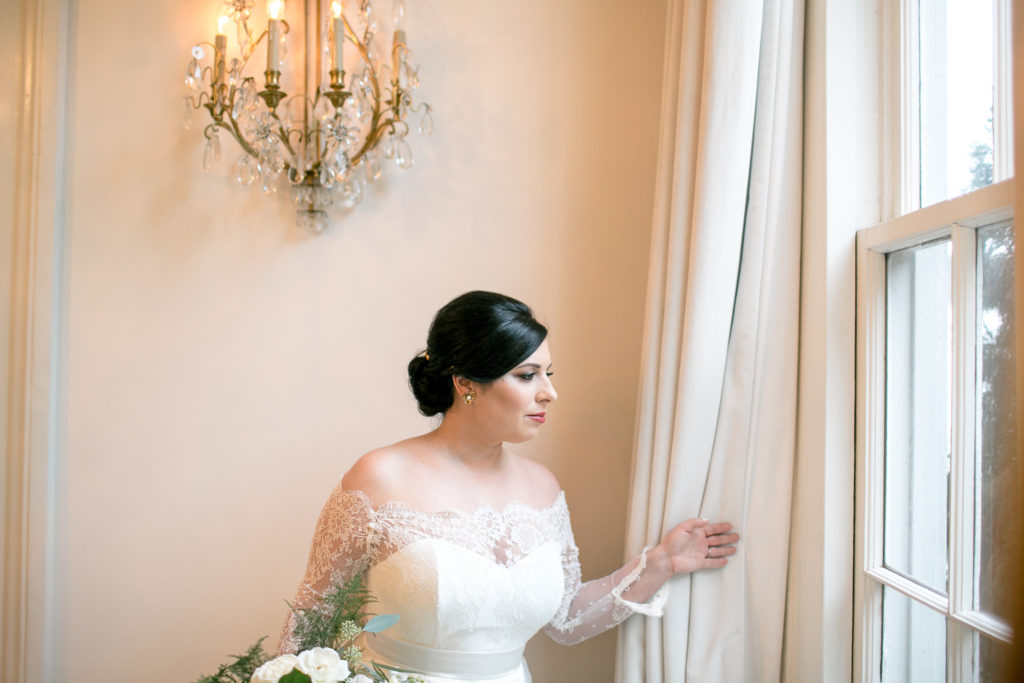 bride looks out window during bridals
