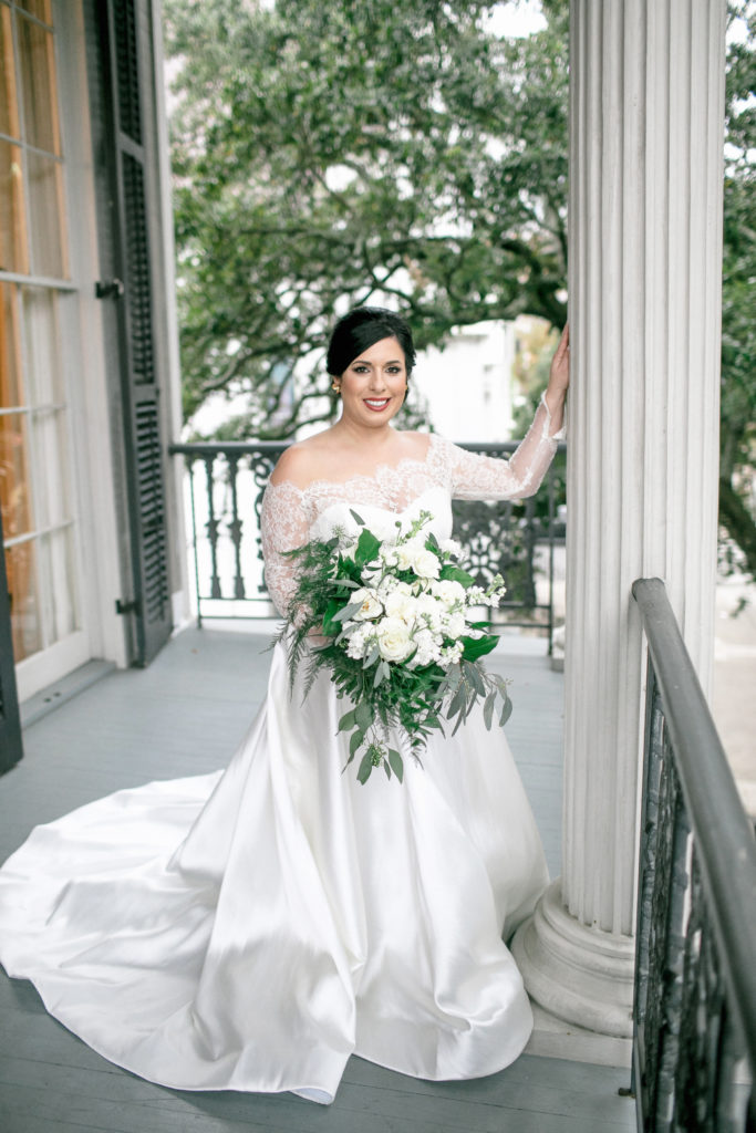 bride poses on porch of jon vaccari house