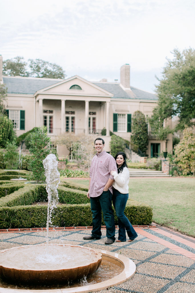 Engaged couple stands in front of Longue Vue House in New Orleans