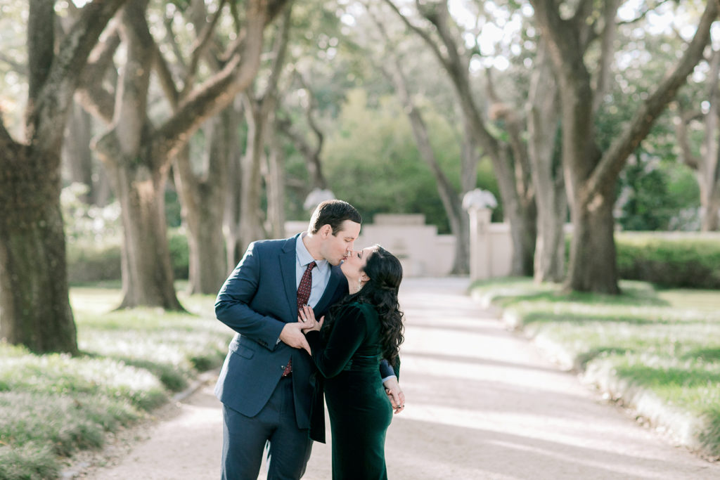 engaged couple kisses at Longue Vue house in New Orleans