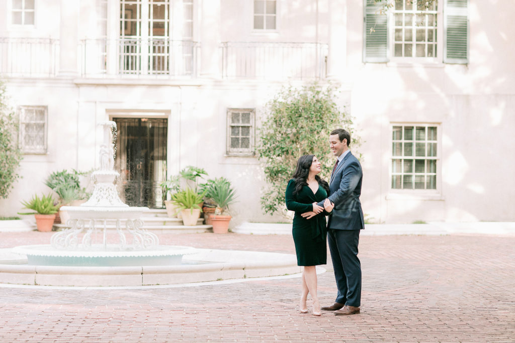 engaged couple poses in front of Longue Vue house in New Orleans