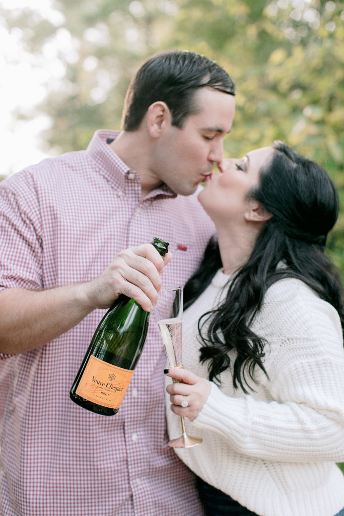 engaged couple toasts with Veuve Cliquot champagne
