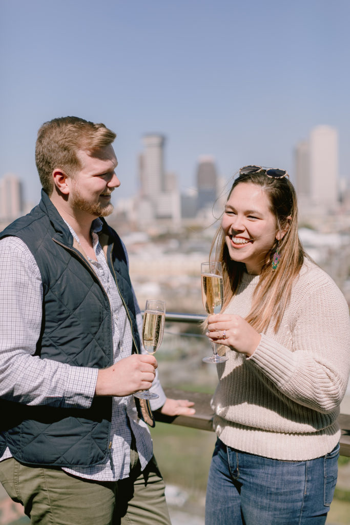 newly engaged couple celebrates with champagne