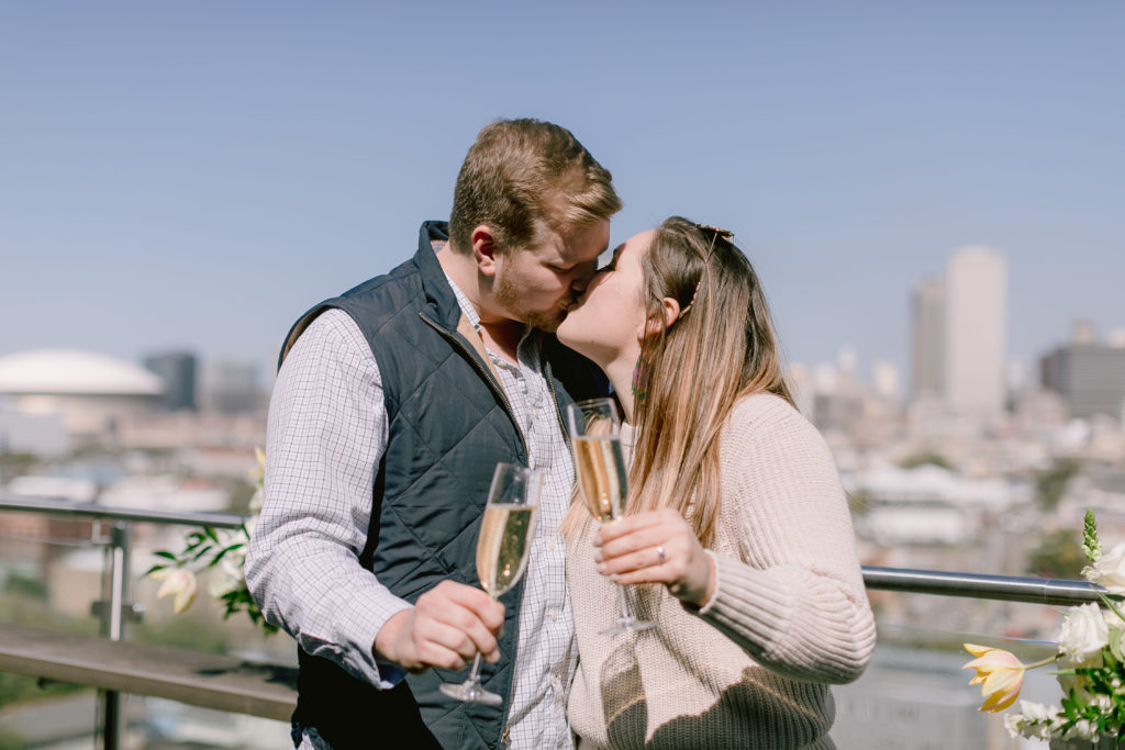 newly engaged couple celebrates with champagne toast