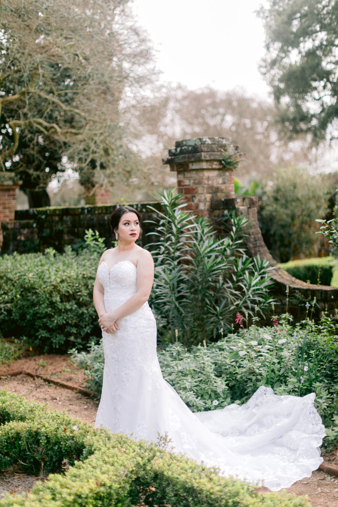 bride posing in a lush garden in new orleans