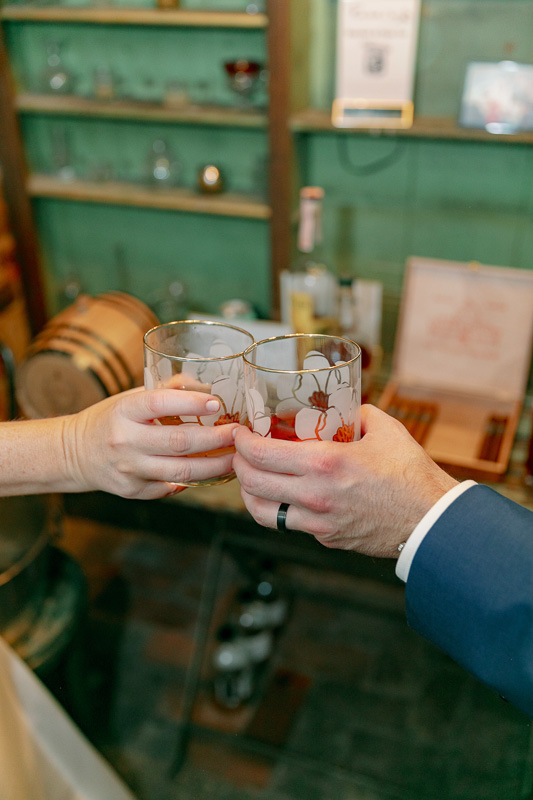 Couple toasting in whiskey bar at Race and Religious Wedding