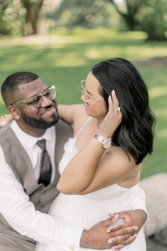 Couple taking engagement photos under the Oaks in New Orleans City Park 