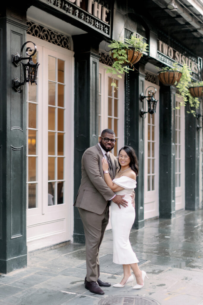 Couple posing in front of Court of Two Sisters in New Orleans